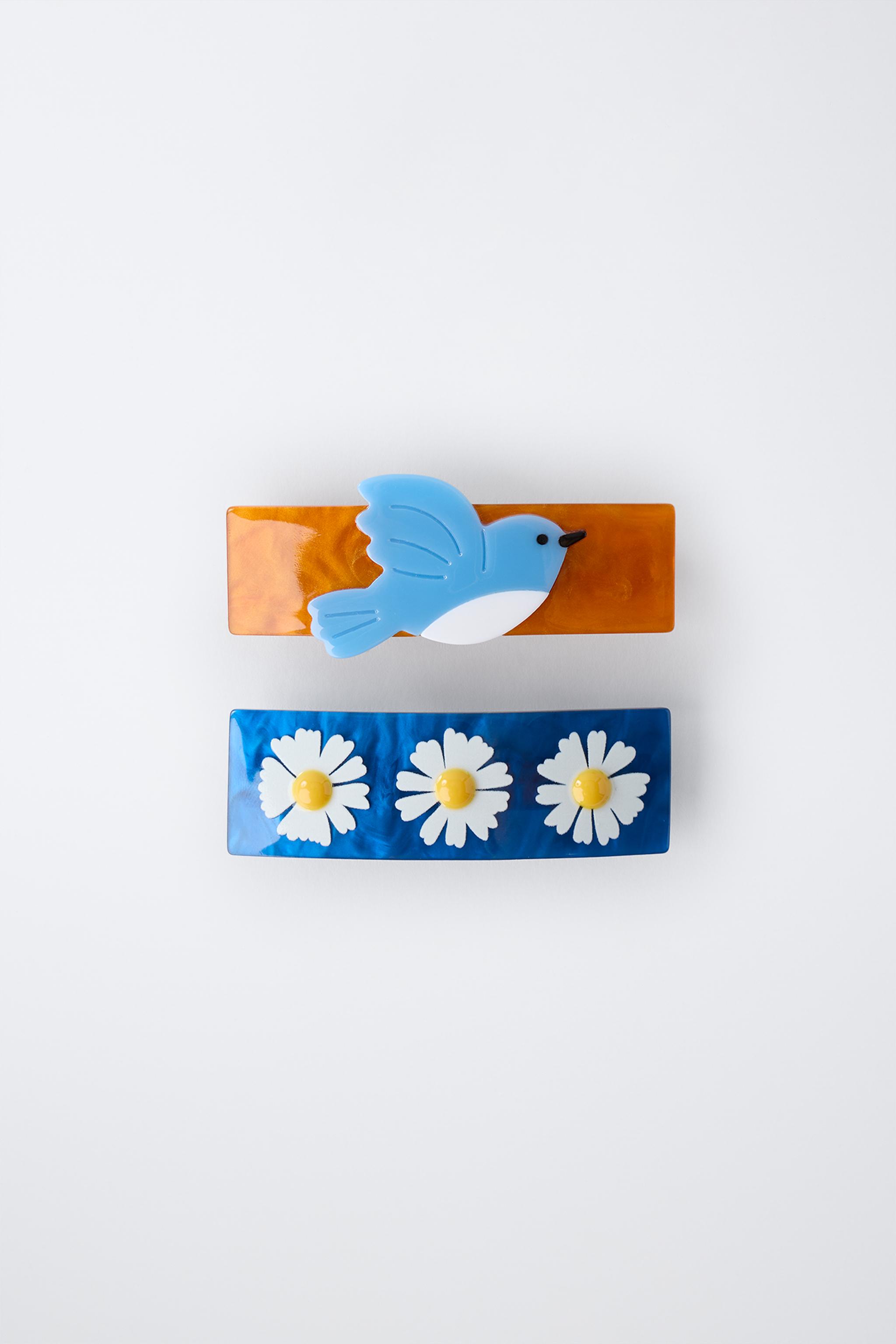 LOT DE DEUX BARRETTES À FLEURS ET OISEAU