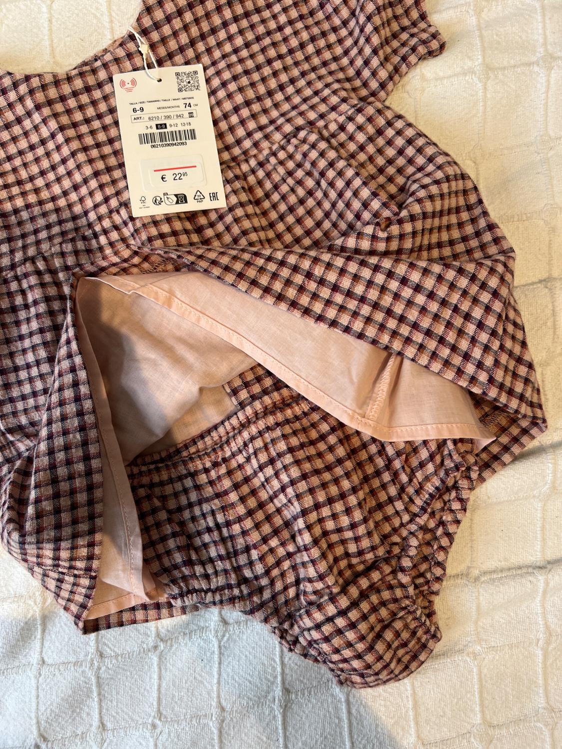 Children's set of brown and pink squares on white fabric. Visible label with a price of £22.95.