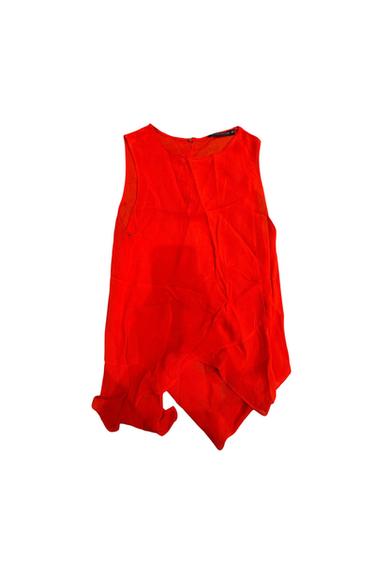 Front view of a sleeveless red blouse with a back zip.