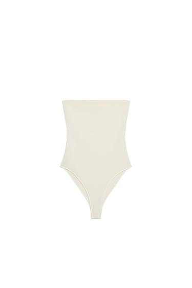 Front view of a strapless, cream-coloured bodysuit.
