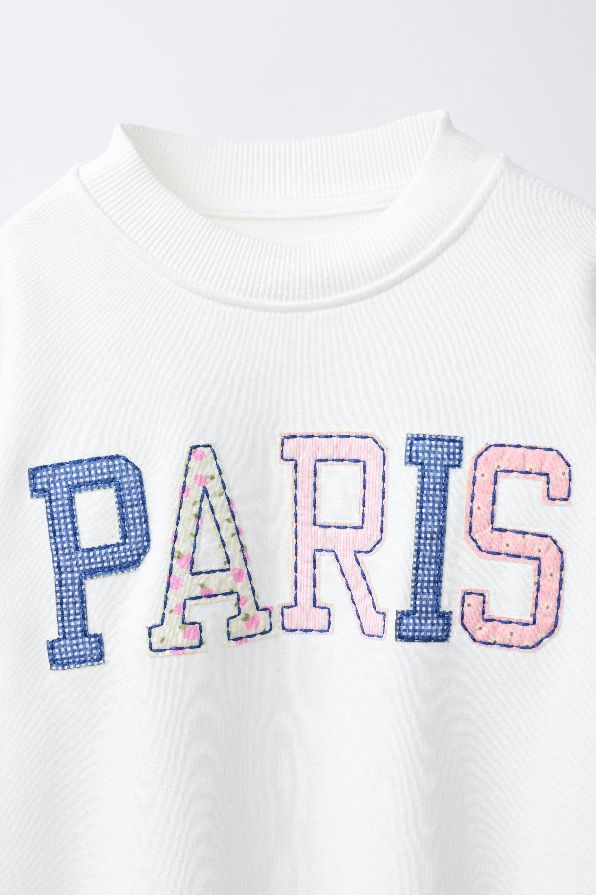 SWEAT AVEC PIÈCES ET INSCRIPTION