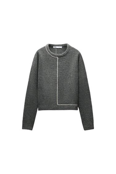 Front view of dark grey jumper with asymmetric white seam.