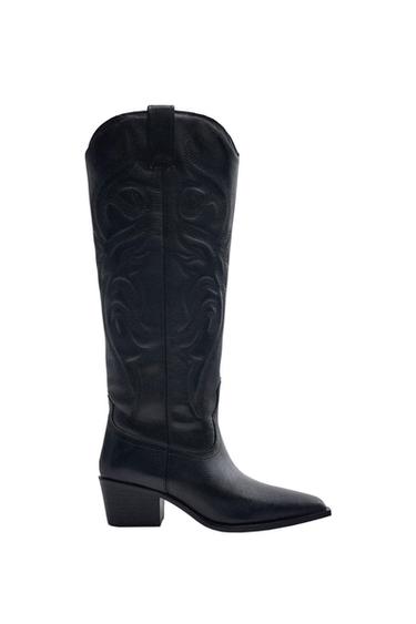 Side view of a black high boot with a square heel and embroidered details.
