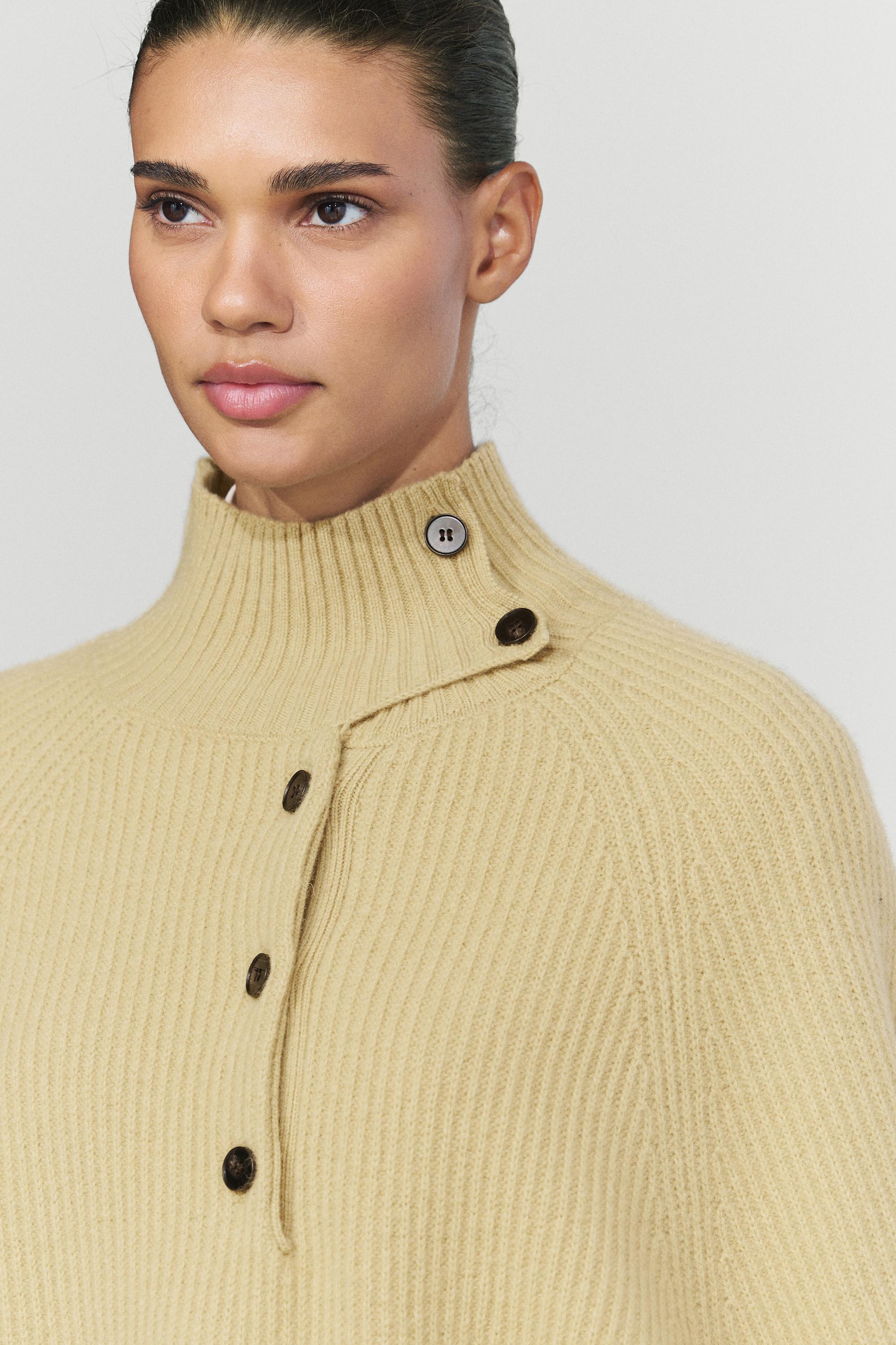 100% wool knit cape with button detail