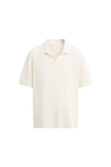 Cream knit shirt with an open collar and short sleeves, on a white background.