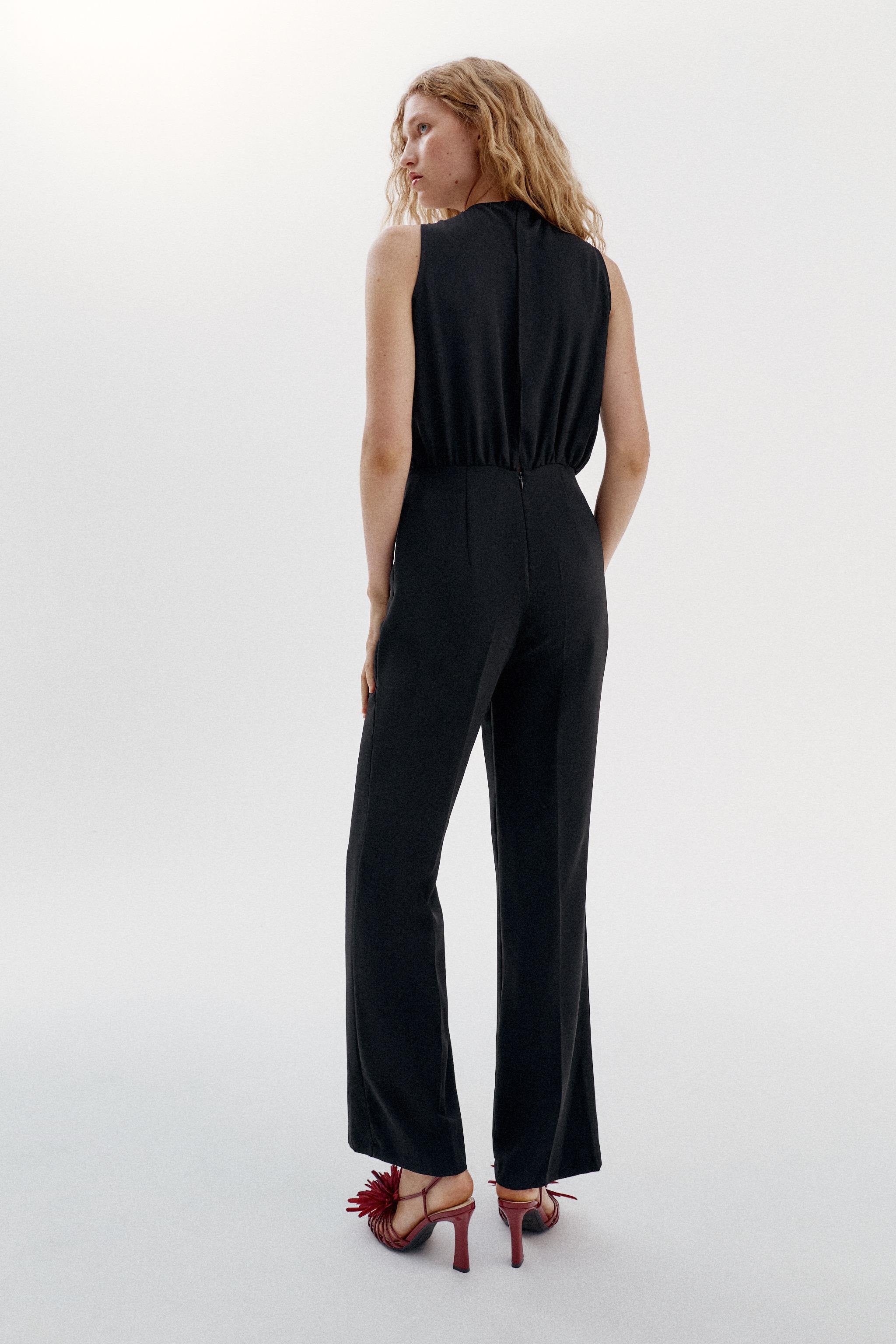 TWISTED NECK FLARE JUMPSUIT