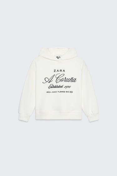 DESSUADORA AMB CAPUTXA I TEXT BRODAT 50TH ANNIVERSARY - Blanc trencat de Zara