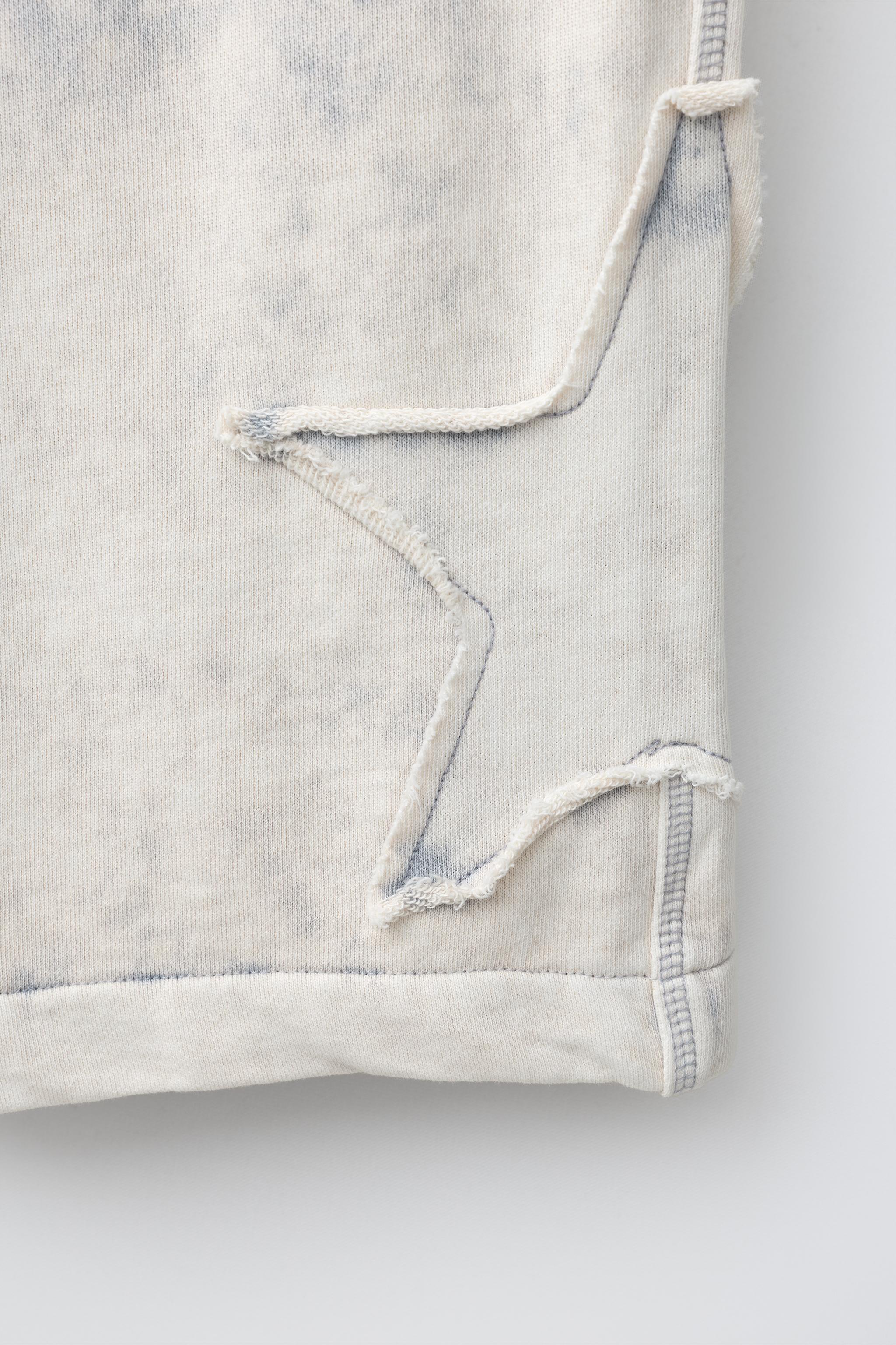 WASHED EFFECT STAR PATCH LONG BERMUDA SHORTS