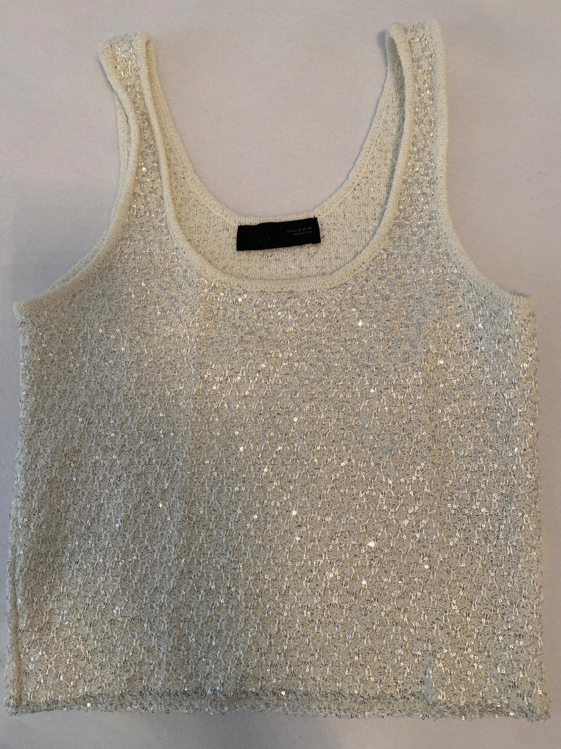 White sleeveless sequined top, on a light background.