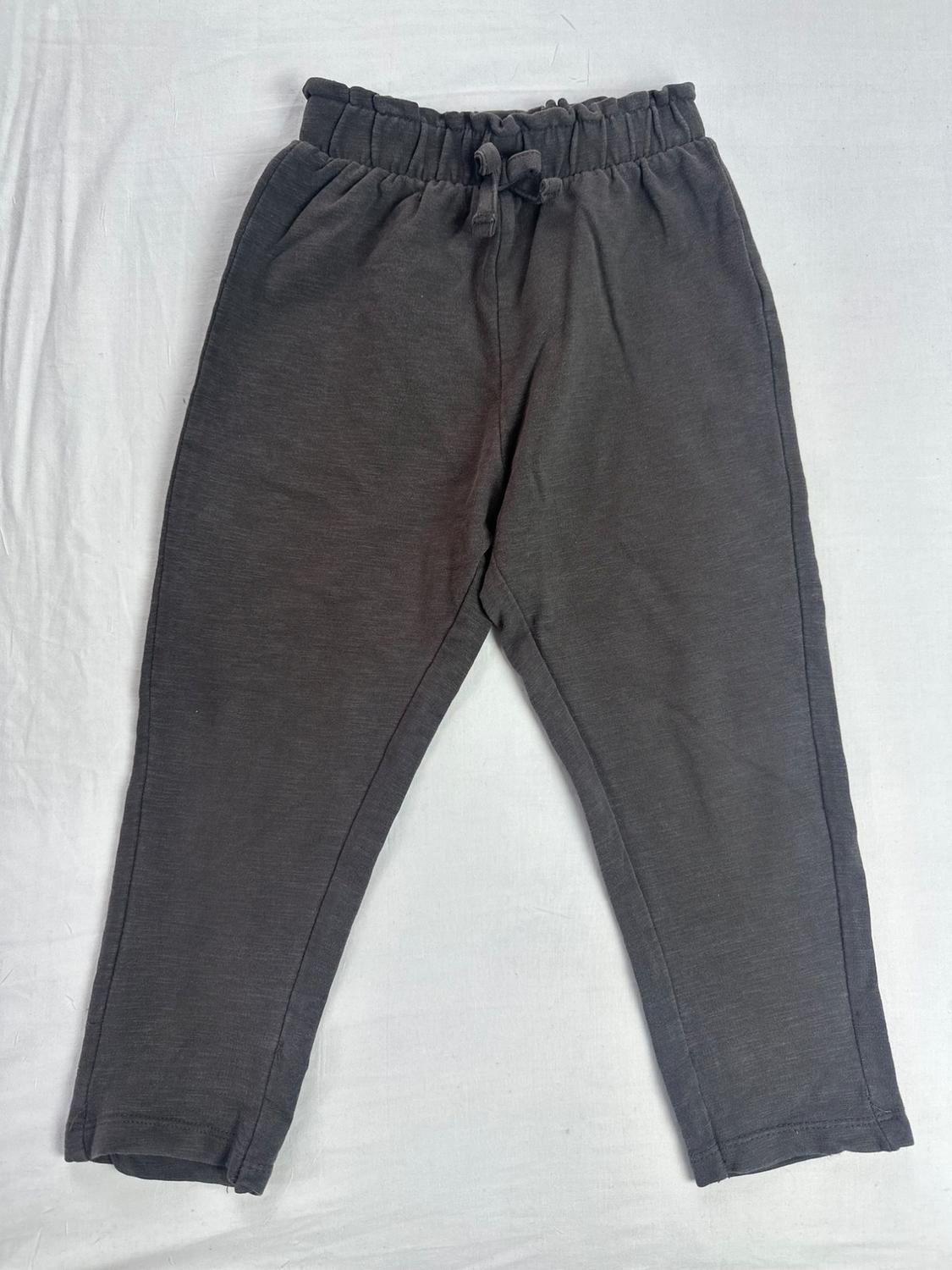 Dark gray drawstring sweatpants with a shirred elastic waistband and an adjustable drawstring, shown against a white background.