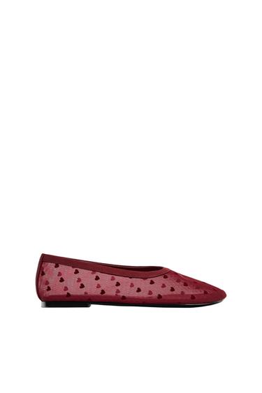 Maroon ballet pump in semi-transparent mesh with a heart print, seen in profile against a white background.