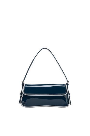 Navy blue shoulder bag with a glossy finish, featuring a flap, white piping, and a thin strap, on a white background.