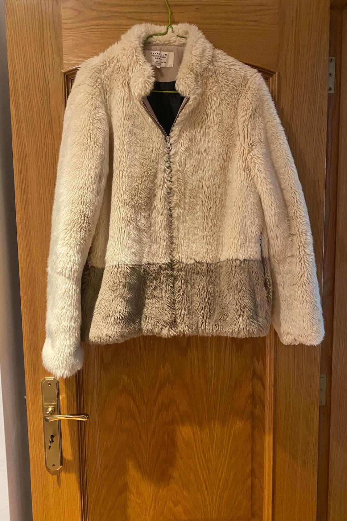 Front view of two-tone zipped teddy jacket with stand-up collar.