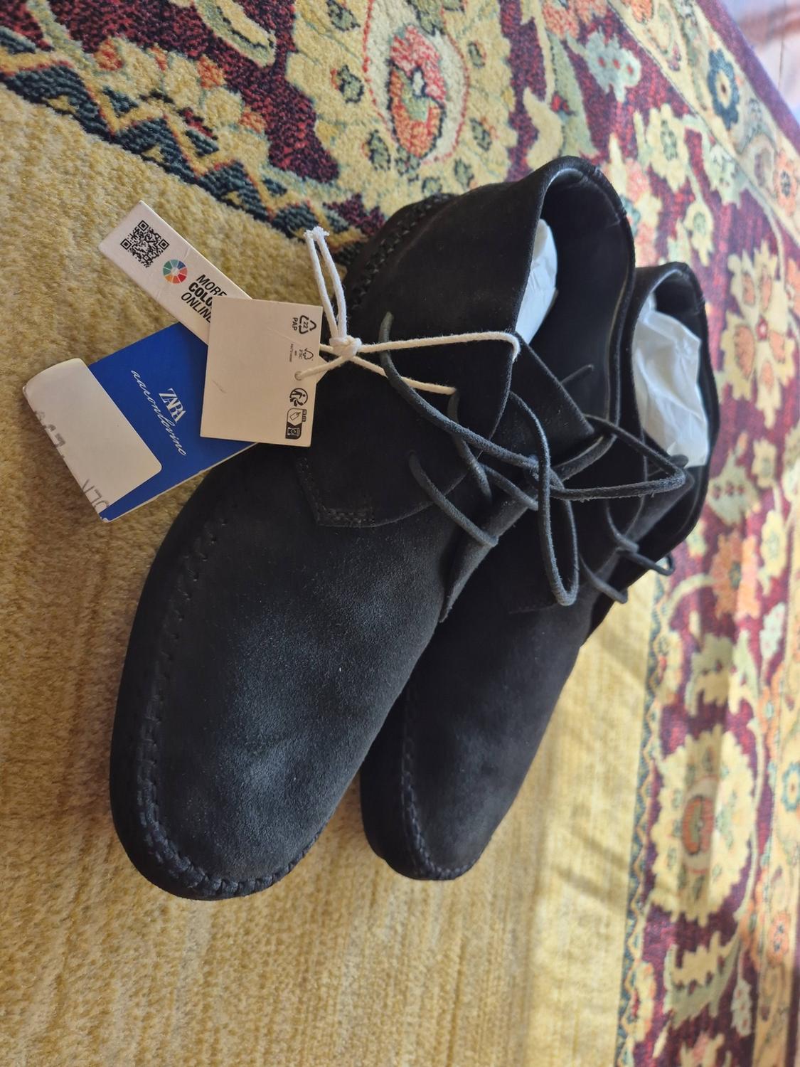 Black suede lace-up shoes on a patterned rug. Tags with the text ZARA aaronlevine.
