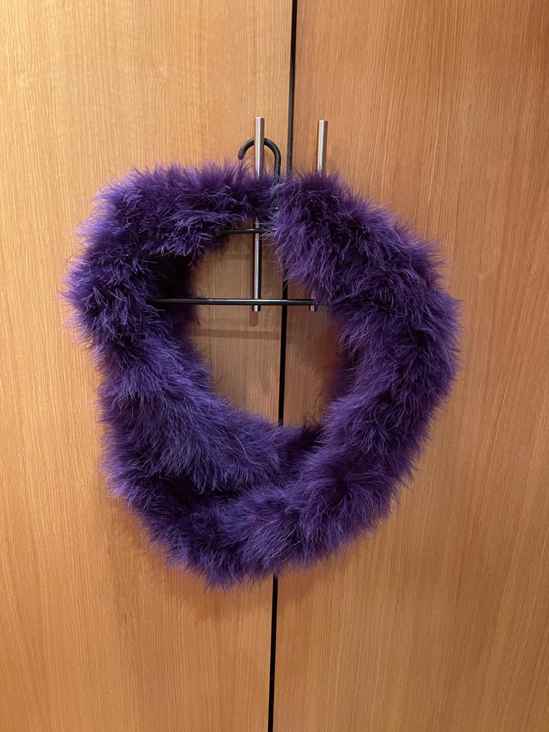 Front view of a fluffy circular scarf in dark purple.