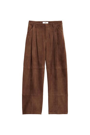 Brown wide-leg pants with front pleats and belt loops. Visible label with the text "ZARA". White background.