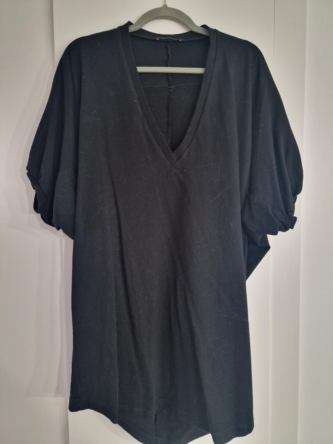 Front view of a black V-neck t-shirt with short puff sleeves.