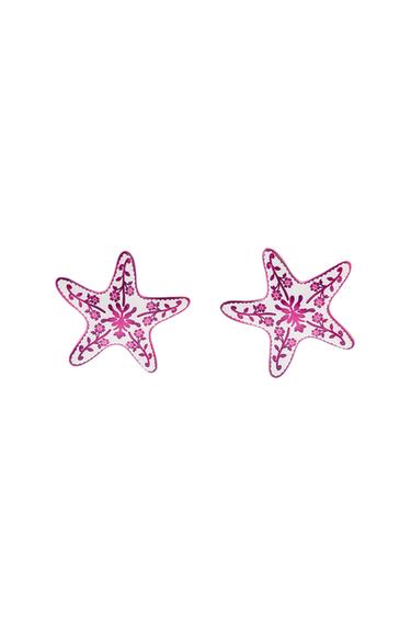 Pair of starfish patches with a floral design in shades of pink on a black background.