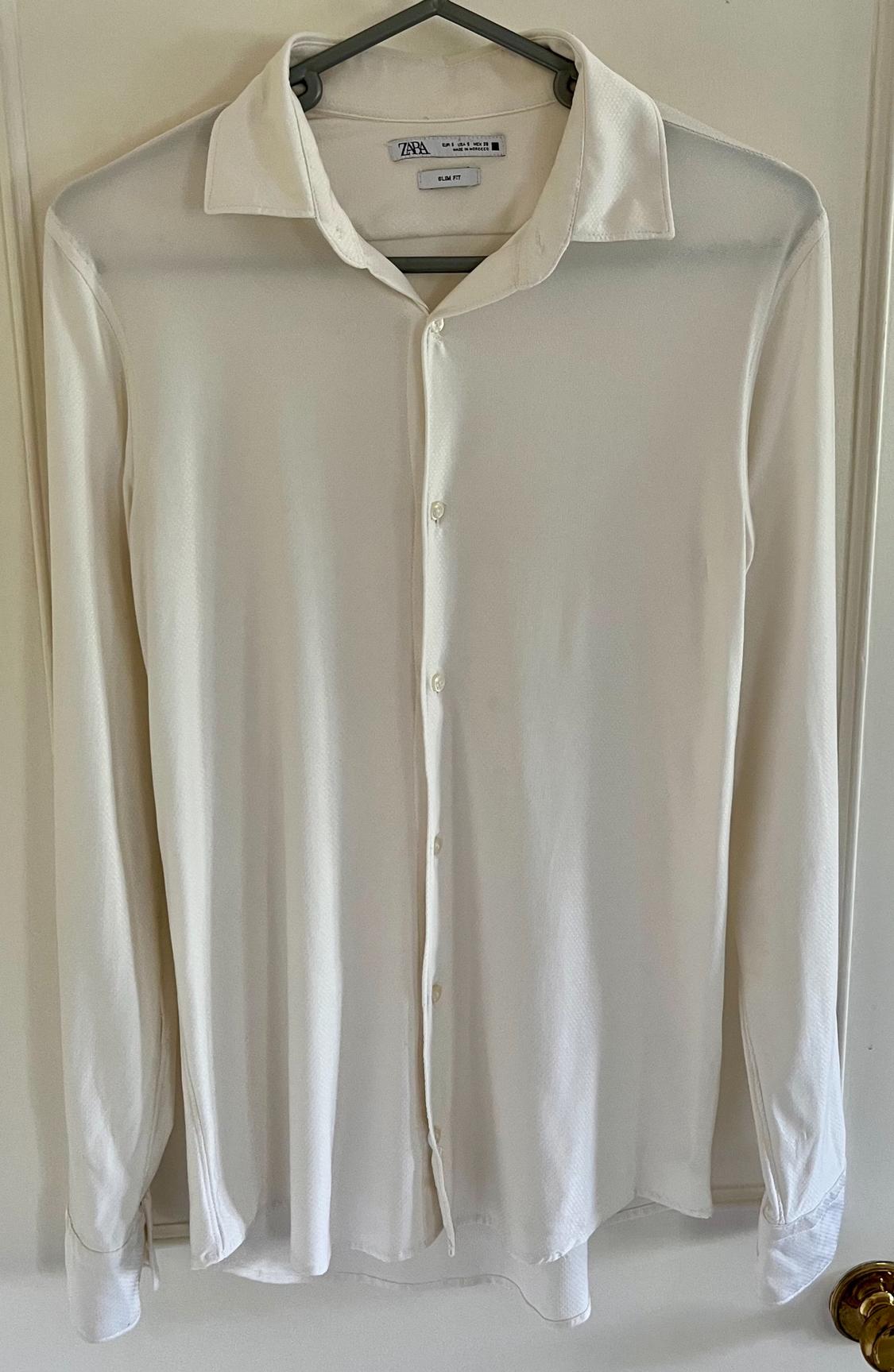 Front view of a long-sleeved white shirt with a full button fastening and a classic collar.