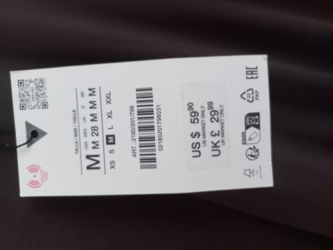 White label on a dark background with a barcode. Text: SIZE M, ART.: 2180/201/798, US $59.90 US MARKET ONLY, UK £29.99 UK MARKET ONLY.