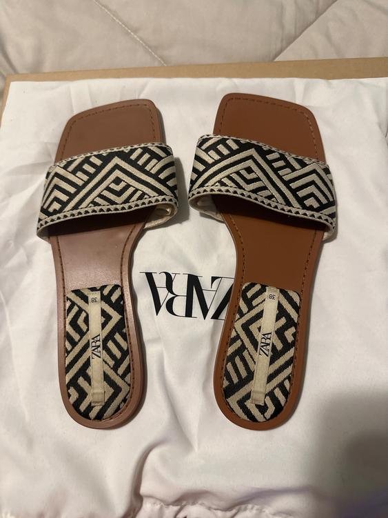Brown sandals with a black and white geometric design on white fabric with a visible ZARA logo.
