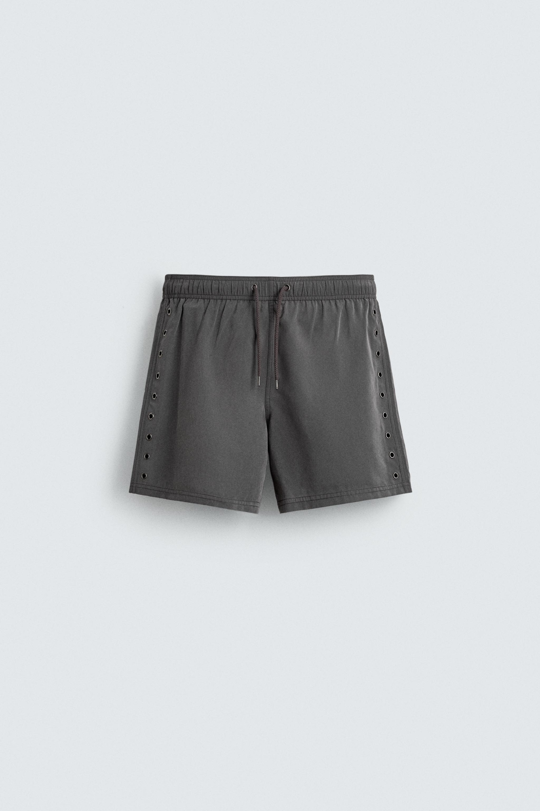 MAILLOT DE BAIN MI-LONG À ŒILLETS MÉTALLIQUES