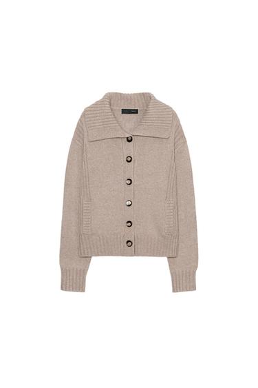 Front view of a dark camel jacket with a notched lapel, long sleeves, welt front pockets and button fastening.