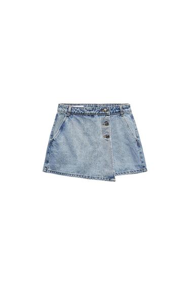 Light blue denim miniskirt with decorative buttons on the front and side pockets. White background.