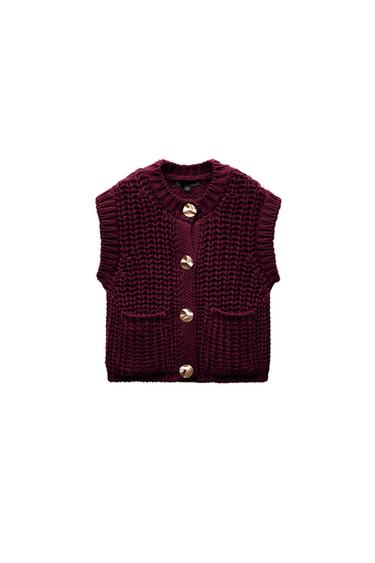 Front view of a burgundy waistcoat with gold buttons and front pockets.