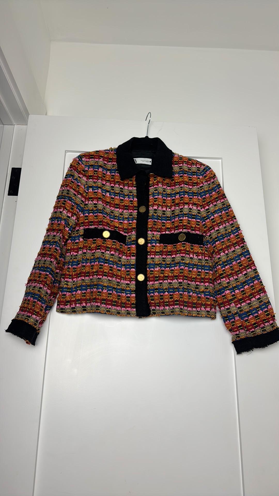 Front view of a multicoloured jacket with gold buttons and black pockets.