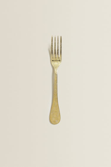 Goudkleurige vork met motief