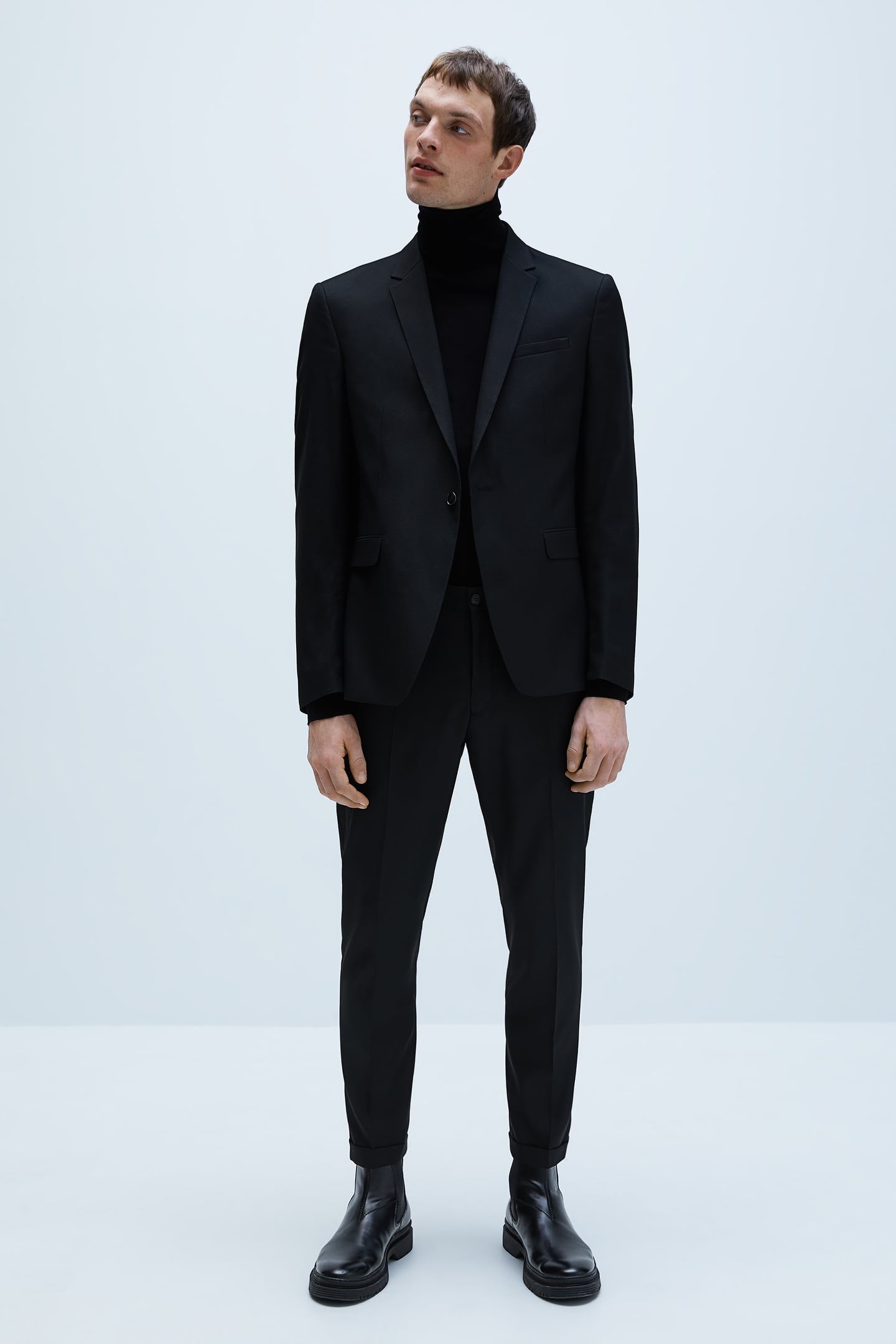 Black suit styled with a roll neck jumper | Vanityforbes