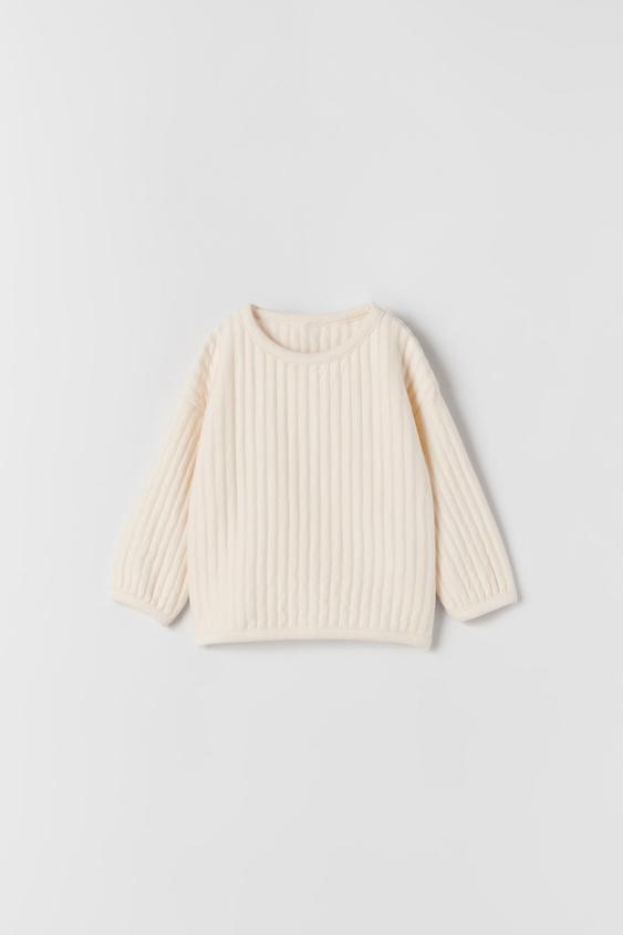 white quilted sweatshirt