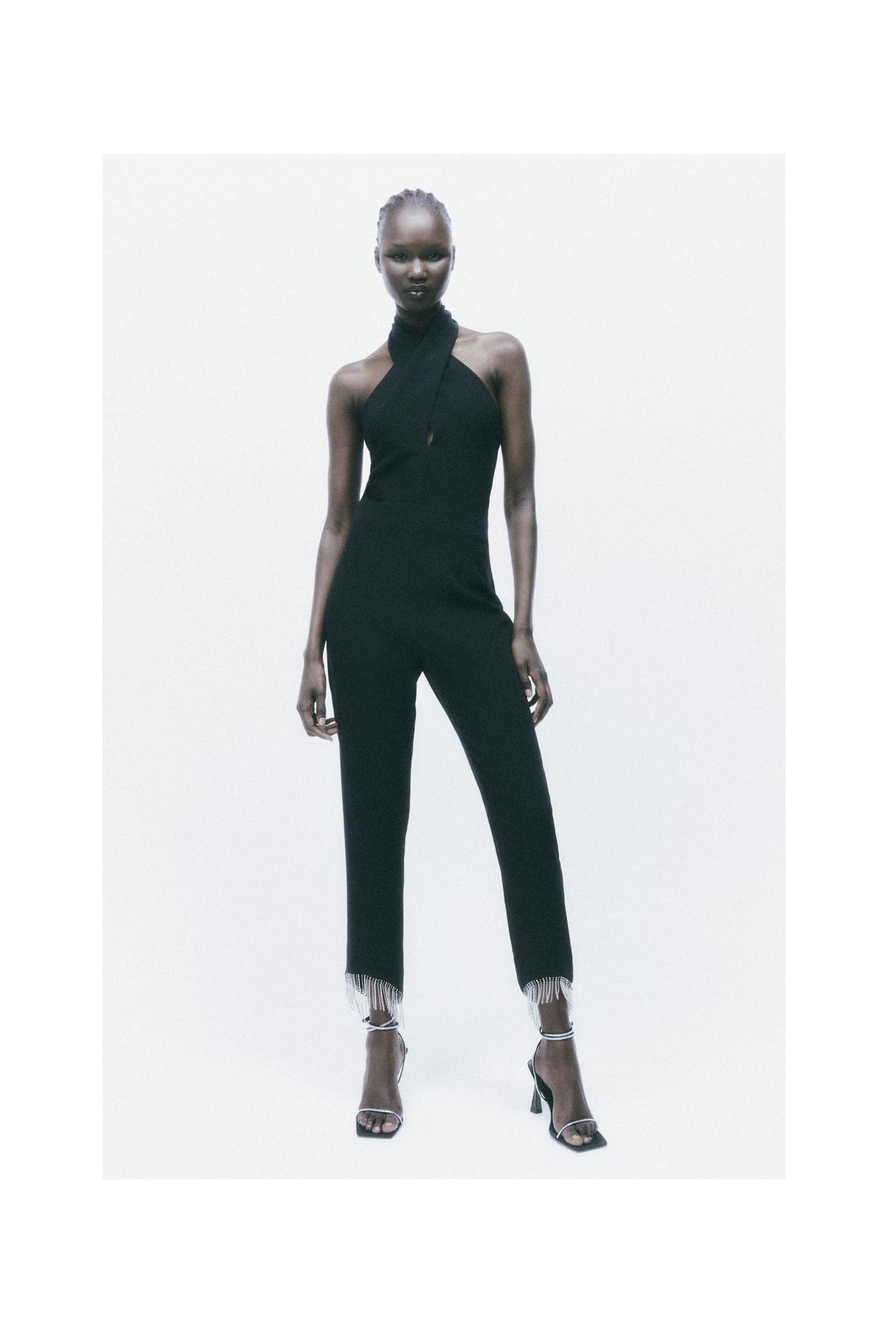 Zara black Cropped jumpsuit with a crossover halter neck and exposed shoulders. Fringed hems with bead appliqués. Invisible back zip fastening.