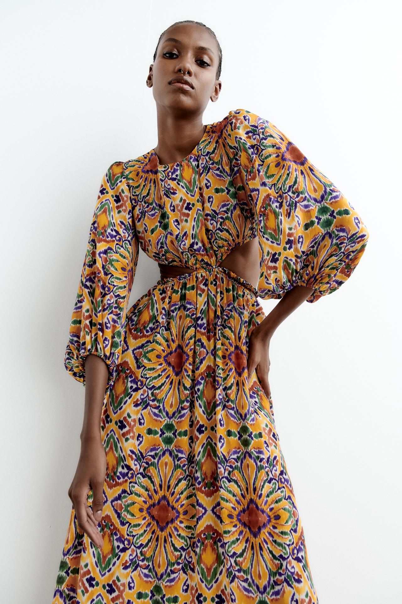 Zara Multicoloured print Round neck dress with puff sleeves falling below the elbow. Featuring an opening at the waist and back with thin criss-cross straps. Elastic trims. Midi length with loose fit skirt and voluminous sleeves.