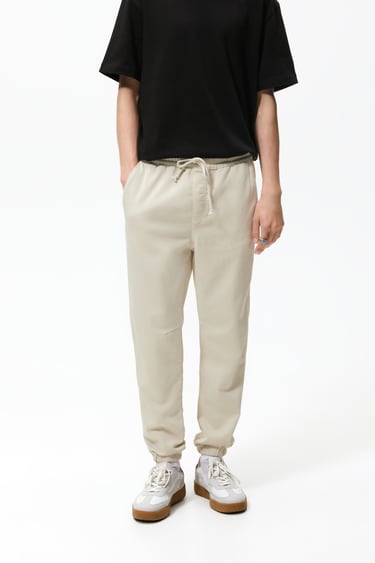 Image 0 of Pants with adjustable drawstring waistband. Front hip pockets and back patch pockets. Washed effect. Elastic cuffs. from Zara