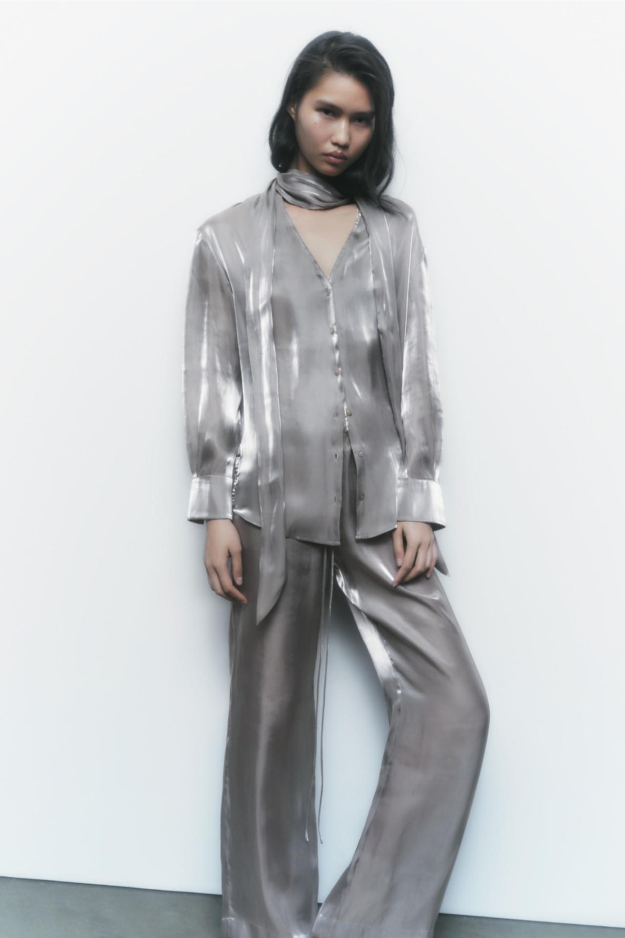 Zara silver slot collar shirt with a tie in the same fabric. Long cuffed sleeves. Vent detail at the back. Button-up front.