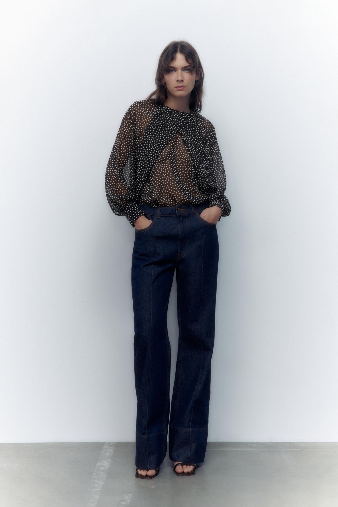 Zara black and white polka dot semi-sheer blouse with a gathered round neck. Long wide cape sleeves with cuffs and a Buttoned opening at the back.