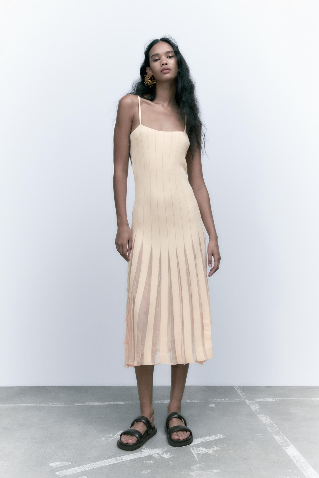 Zara Cream knit Midi dress with a straight-cut neckline and thin straps. Fitted to the body and flaring out to a fuller skirt with pleated detailing and sheer panel details.