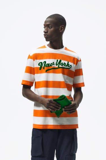 Image 0 of STRIPED T-SHIRT WITH SLOGAN from Zara