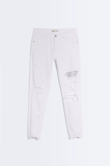 Image 0 of Skinny fit jeans. Five pockets. Washed effect with rips at leg and interior patch. Front zip and button closure. from Zara