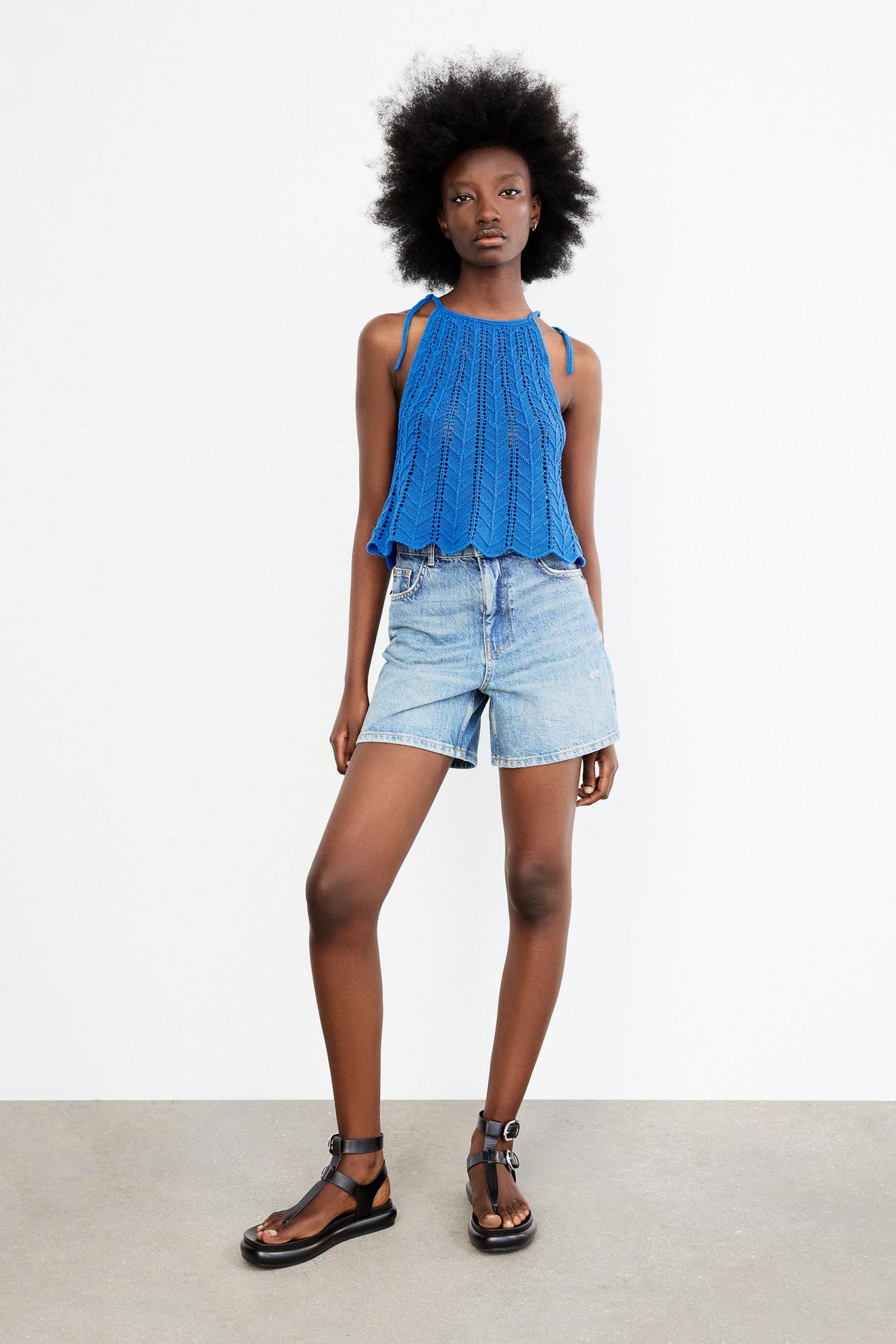 Cornflower blue open-knit top with thin tie straps close to the neck and scalloped hem.