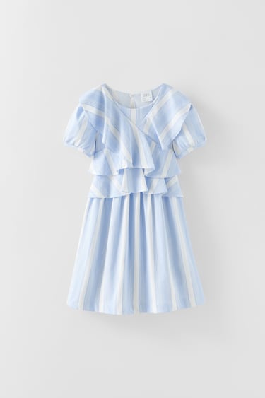 Dress with round neck and short sleeves. Buttoned back teardrop closure. Ruffle appliqué.