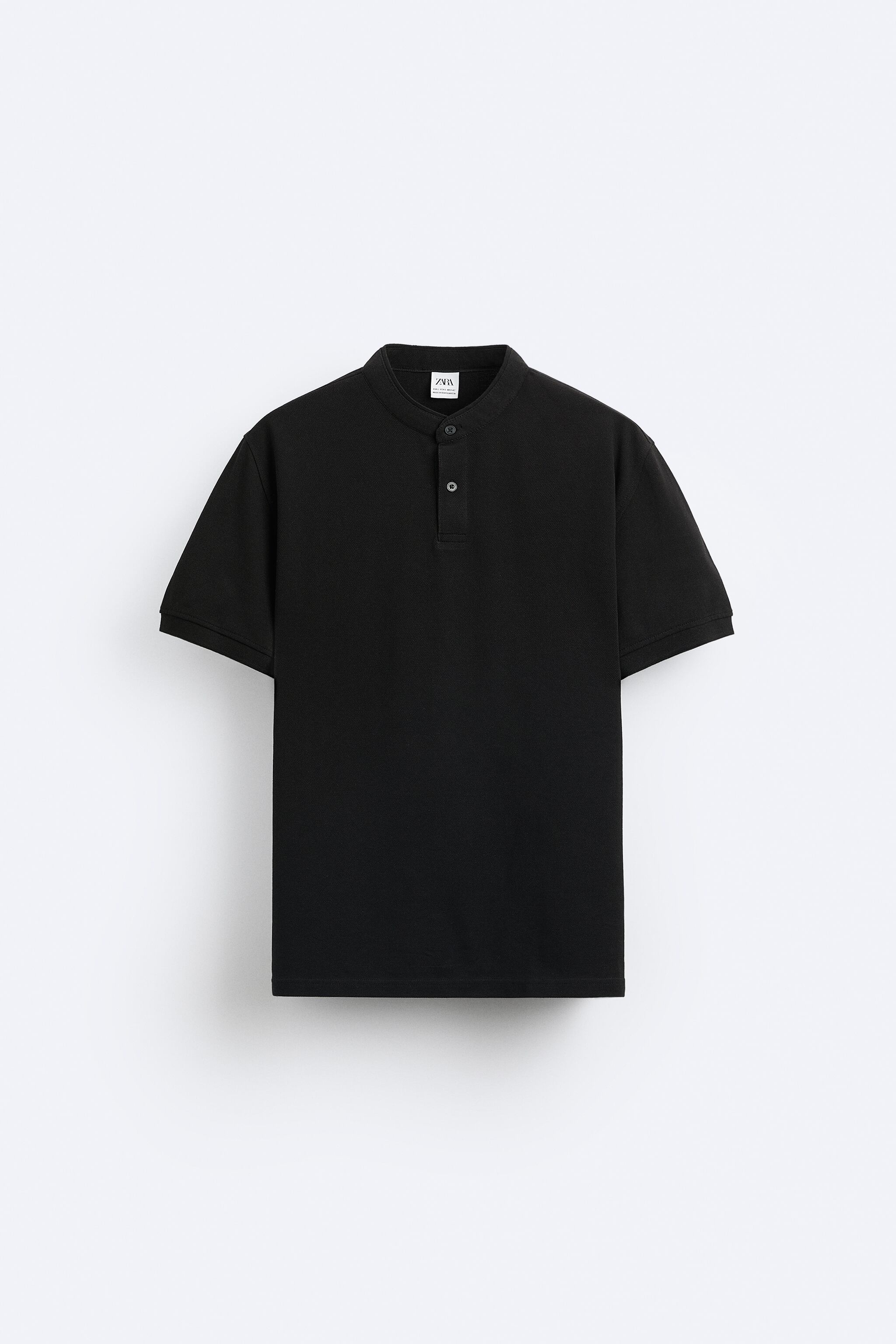 Band collar shirt with front button closure and short sleeves. Side vents at hem.