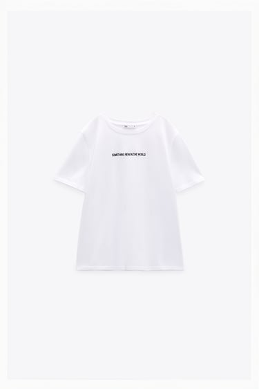 Image 0 of T-shirt made of cotton. Round neck and short sleeves. Contrasting text at front. from Zara