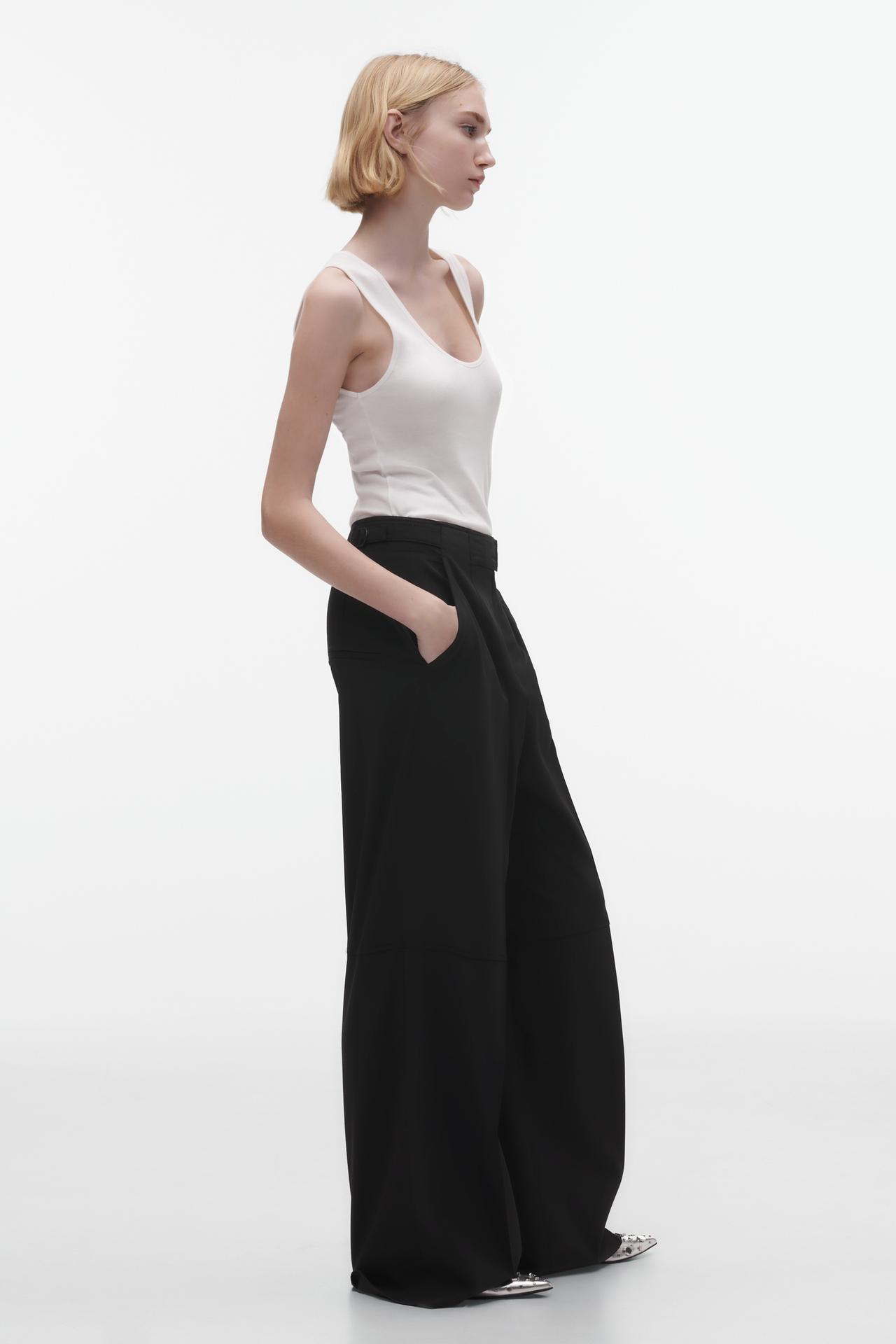 Zara WOOL BLEND DARTED TROUSERS. These black flowing trousers made of a wool blend fabric. Adjustable waistband with metal buckle. Dart details on the front. Wide-leg design. Front zip fly, button and metal hook fastening.