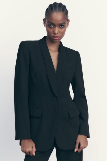 Image 0 of Long sleeve lapel collar blazer. Welt pockets with flaps at front. Front button closure. from Zara