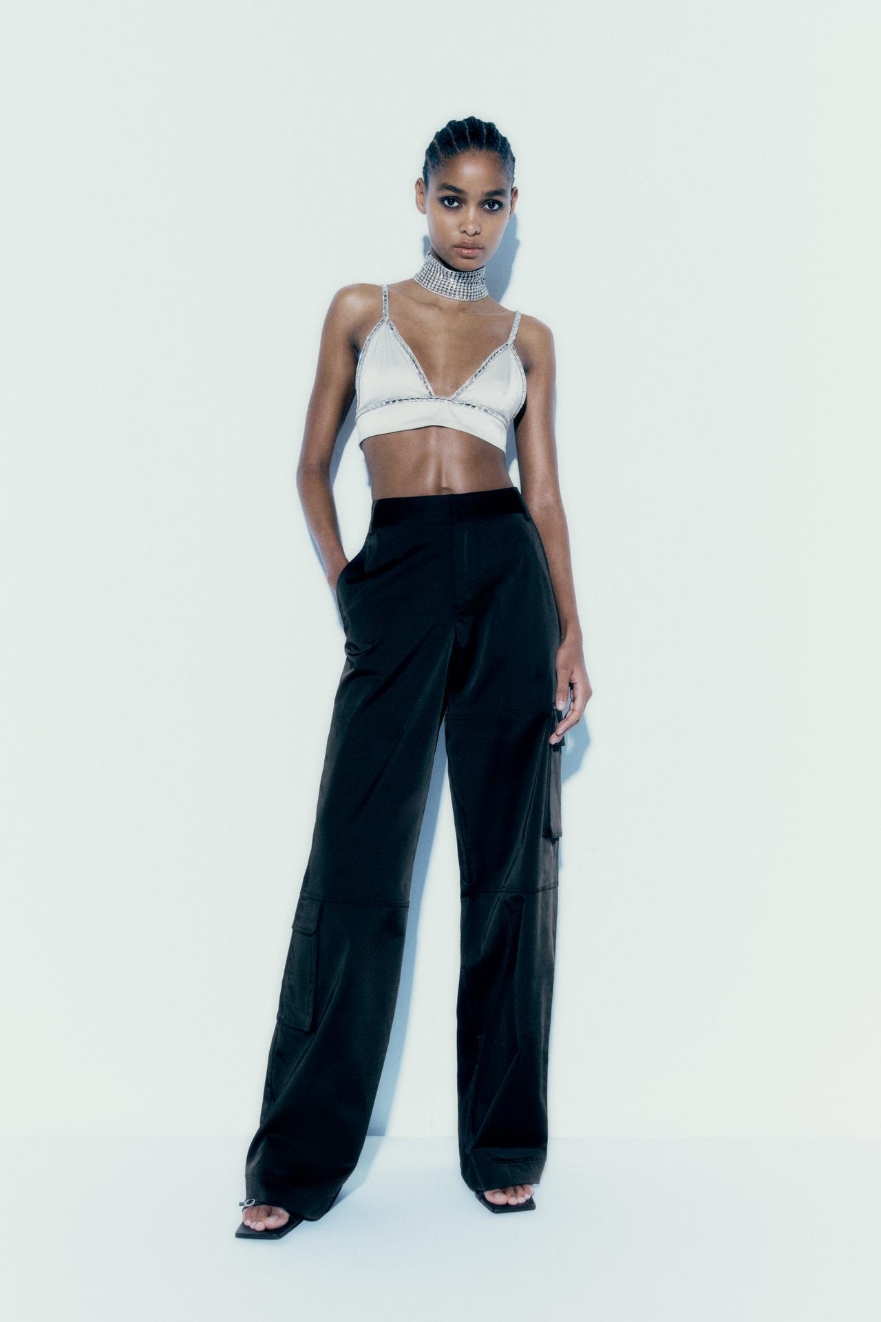 Zara black satin Mid-waist cargo trousers. Featuring front patch pockets with flaps on the leg, flap pockets at the back, a straight leg and metal hook, mid rise waist, button and zip fastening at the front with belt loops.