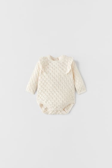 Image 0 of TEXTURED OPENWORK KNIT BODYSUIT WITH RUFFLES from Zara