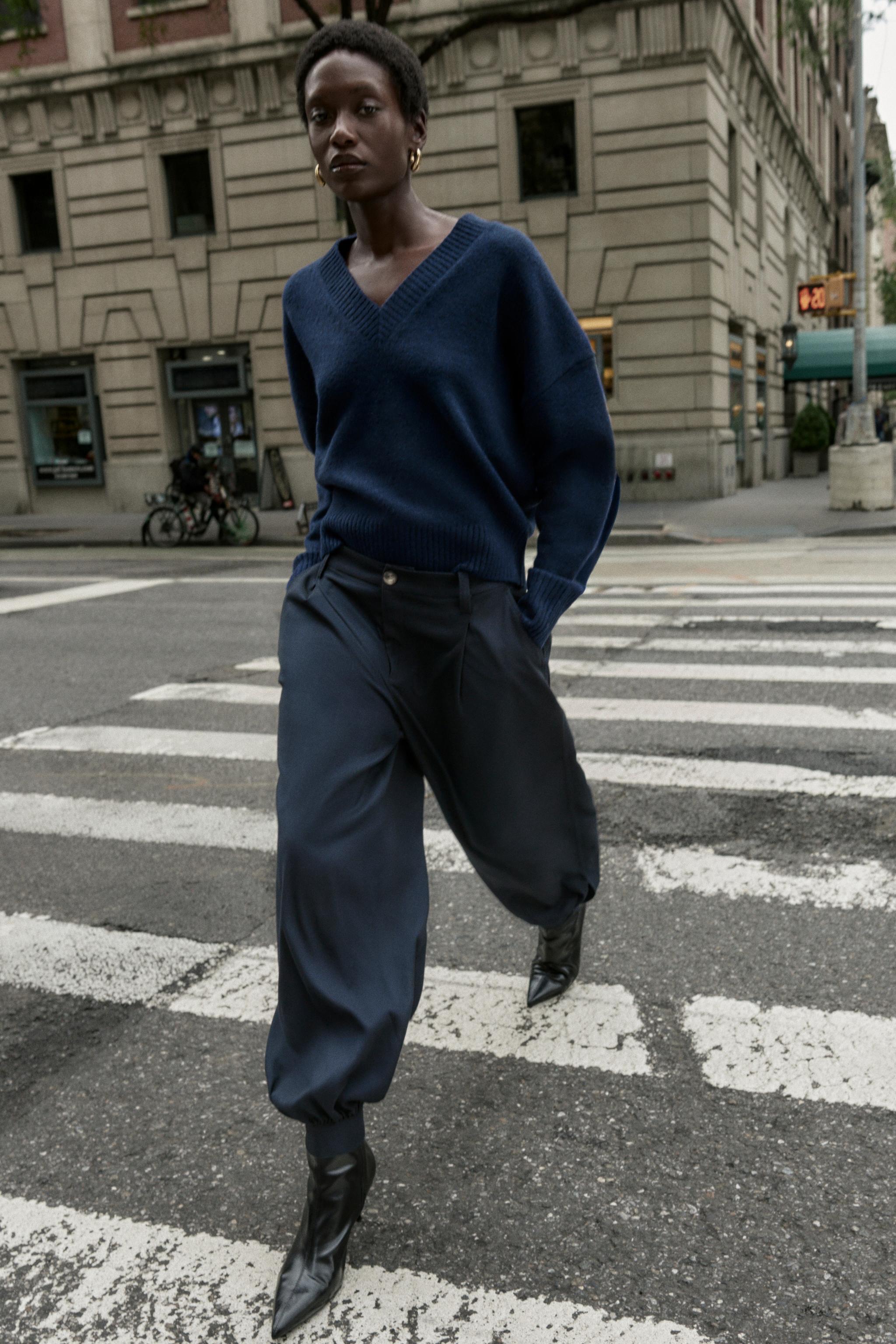 PLEATED TROUSERS WITH BUTTONED HEM